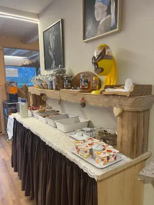 a table with food on a pink table cloth at Chalet Valeruz in Canazei