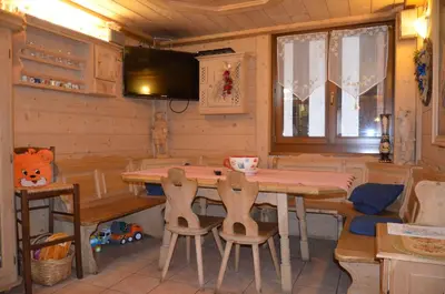 a bedroom with a bed with pink pillows at Chalet Valeruz in Canazei