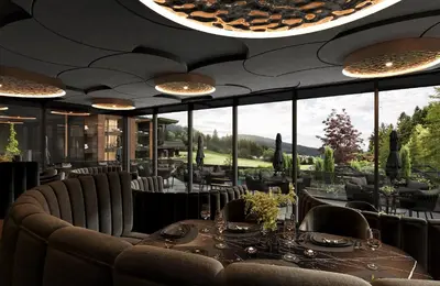 a wooden table topped with plates of food and drinks at Alpine Spa Resort Viktoria in Avelengo