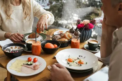 a table topped with plates of food and drinks at Hotel Hirzer 2781 in Avelengo