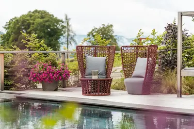 a view of a pool with mountains in the background at Hotel Hirzer 2781 in Avelengo