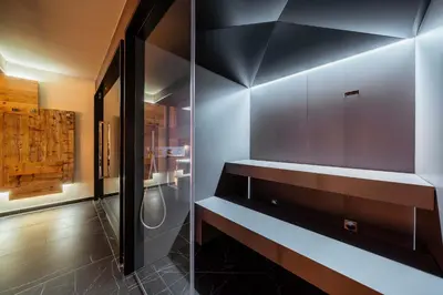a bathroom with a black and white wall at Hotel Cristallino d'Ampezzo in Cortina dʼAmpezzo