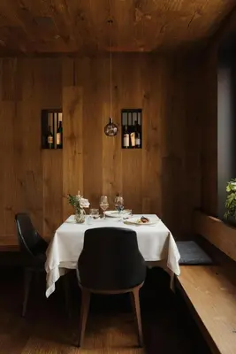 a dining room with a white table and chairs at Hotel Genziana in Ortisei