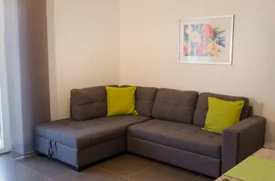 a couch with two yellow pillows in a living room at Residence Reinhild in Nalles