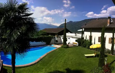 a backyard with a swimming pool and a house at Residence Reinhild in Nalles