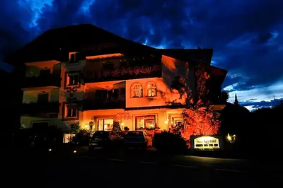 a house is lit up at night at Residence Reinhild in Nalles