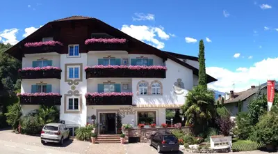 a large white building with flowers on the balconies at Residence Reinhild in Nalles