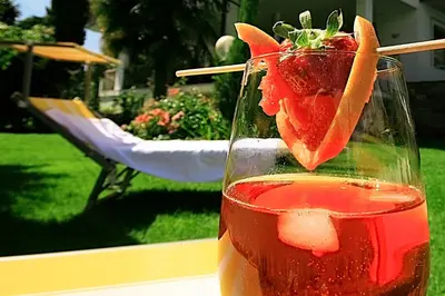 a vase with a strawberry in it on a table at Residence Reinhild in Nalles