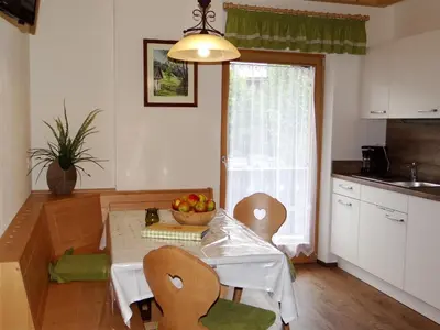 a kitchen with a table with a bowl of fruit on it at Hochwieserhof in Monguelfo