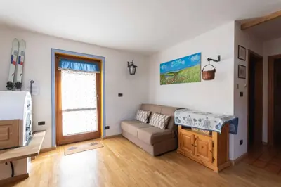 a living room with a couch and a window at Casa Riccardo in Soraga