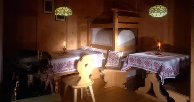 a room with two beds and two candles in it at Hotel Vigo in Vigo di Fassa