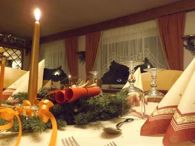 a table with a candle and christmas decorations on it at Hotel Vigo in Vigo di Fassa