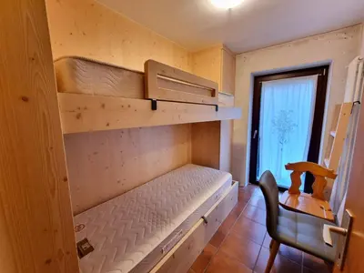 a bedroom with a bunk bed and a chair at Scorpion in Mazzin