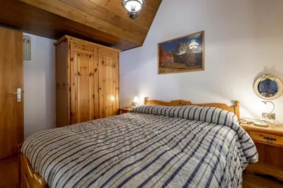 a bedroom with a bed with a striped comforter at Scorpion in Mazzin