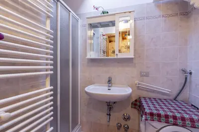 a bathroom with a sink and a toilet and a mirror at Scorpion in Mazzin