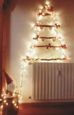 a christmas tree with a bird sitting in front of it at Casa Ciotoli in Falcade