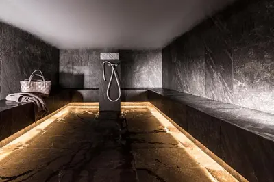 a bath tub with a sign in the middle of a room at Mair Am Ort Living Hotel B&B in Parcines