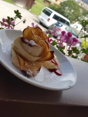 a white plate with a dessert on a table at Villa Gemmy in Pozza di Fassa