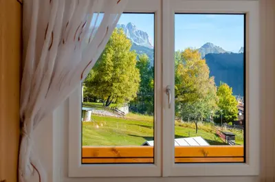 a window with a view of a mountain at Villa Gemmy in Pozza di Fassa