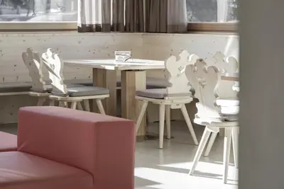 a table and two chairs and a table and a table and chairs at Hotel Gardenazza in Badia
