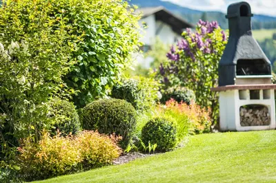 a garden with a bird house in the grass at hubertus dolomites in Fiè