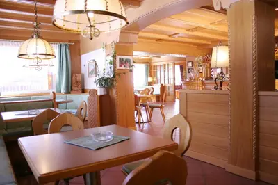an empty lobby with an archway and a building at Hotel Cima Dodici in Vigo di Fassa