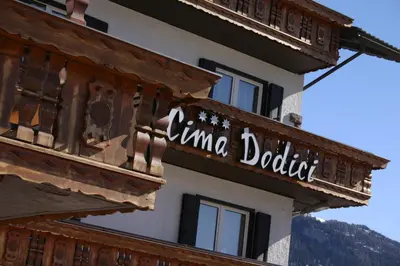 a sign on the side of a building at Hotel Cima Dodici in Vigo di Fassa