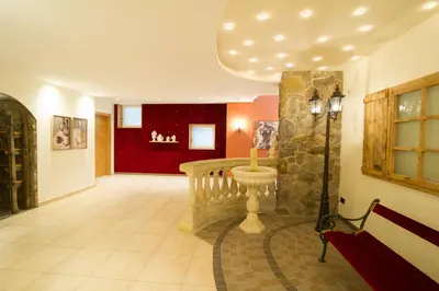a hallway with a staircase and a red wall at Panorama in Termeno