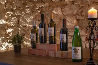 a group of wine bottles on a table with a candle at Panorama in Termeno