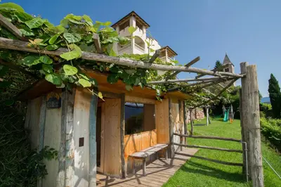 a building with a bench on the side of it at Panorama in Termeno