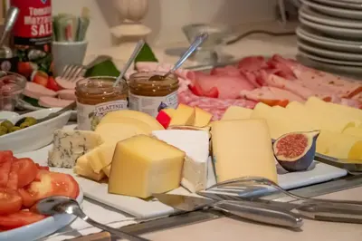 a plate of cheese and other foods on a table at Panorama in Termeno