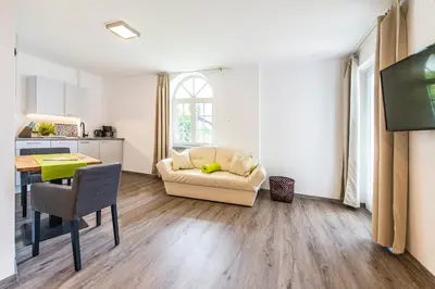 a living room with a couch and a table at Apartments Graf Hartwig in Schenna