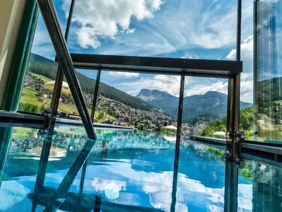 a view of a swimming pool from a building at Alpin & Vital Hotel La Perla in Ortisei