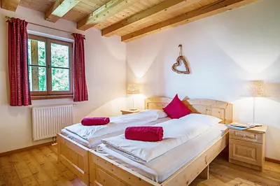 a bedroom with a large bed with red pillows on it at Sprechenstein in Vipiteno
