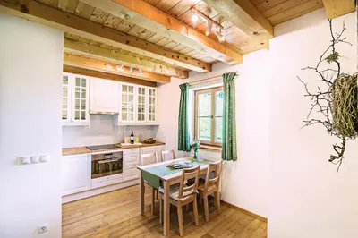 a kitchen with a table and chairs in a room at Sprechenstein in Vipiteno