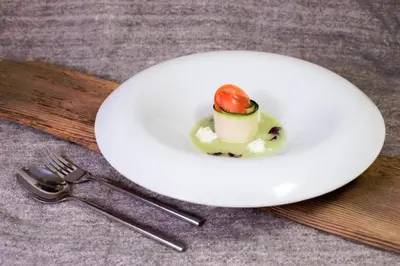 a white plate with a dessert with a strawberry on it at Sprechenstein in Vipiteno