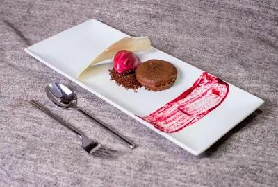 a white plate with a piece of chocolate cake on it at Sprechenstein in Vipiteno