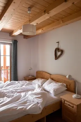 a bedroom with a large bed with white sheets at Sprechenstein in Vipiteno