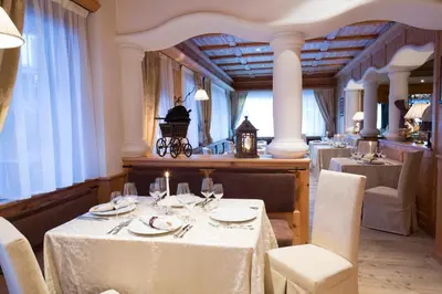 a dining room with a table and chairs and a table and chairsktop at Sport Hotel Majarè in Pozza di Fassa