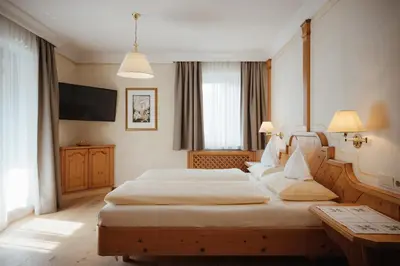 a hotel room with a bed and a couch at Gourmet Hotel Gran Ander in Badia