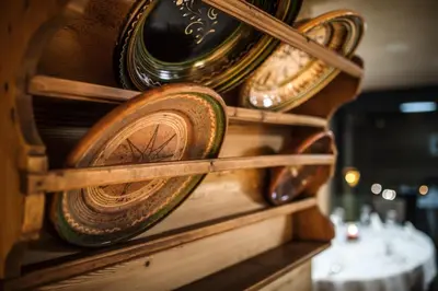 a table with wine glasses and a view of a mountain at Gourmet Hotel Gran Ander in Badia