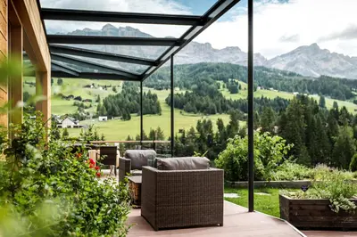 a patio with two lounge chairs and a house at Gourmet Hotel Gran Ander in Badia