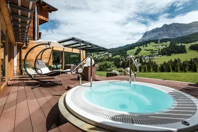 a hot tub with a view of a mountain at Gourmet Hotel Gran Ander in Badia