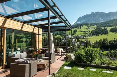 a glass house with a view of the mountains at Gourmet Hotel Gran Ander in Badia