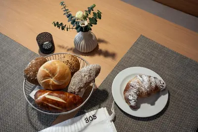 a table with two plates of different types of bread at Alagundis Apartment Residence in Lagundo