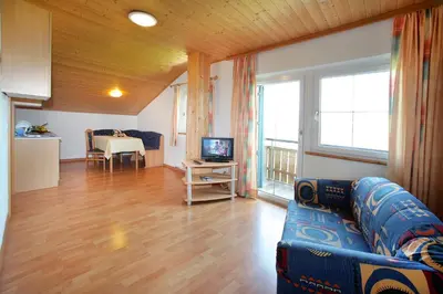 a living room with a couch and a television at Residence St Konstantin in Fiè