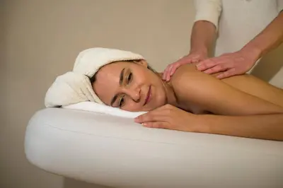a woman getting a massage in a bath tub at Residence St Konstantin in Fiè