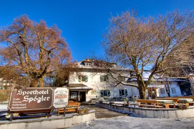 a sign in front of a building with trees at Sporthotel Spoegler in Collalbo