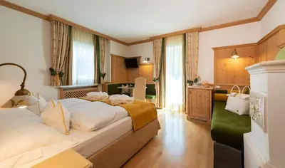 a bedroom with a large bed in a room at Hotel Teresa in San Vigilio Di Marebbe