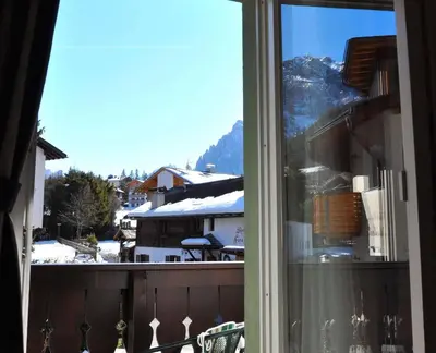 a view of a snowy mountain from a window at Hotel Teresa in San Vigilio Di Marebbe